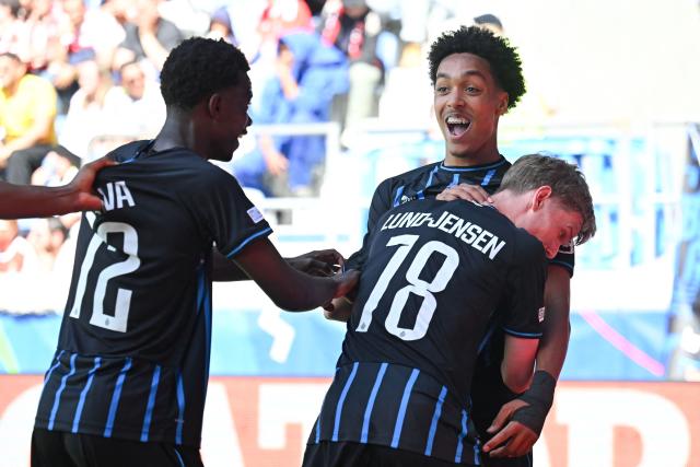 Club Brugge's English defender #90 Andre Garcia (R) celebrates with teammates scoring his team's second goal during the UEFA Youth League semi-final football match between Benfica and Club Brugge at Stade de la Tuiliere in Lausanne, on April 17, 2026. (Photo by Fabrice COFFRINI / AFP)