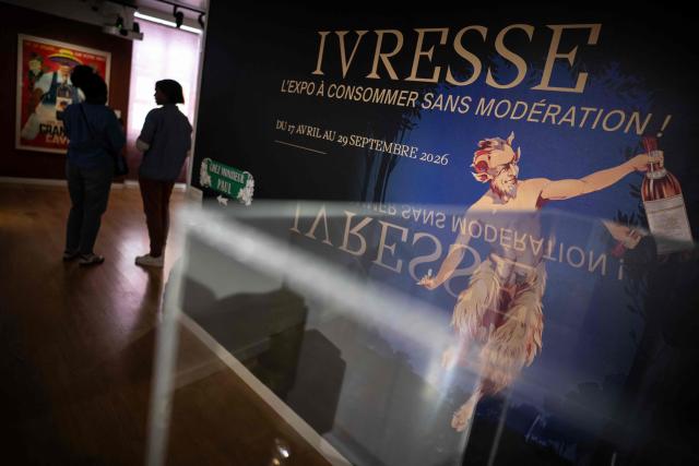 Visitors tour the "Ivresse" (Drunkenness) exhibition, which explores how intoxication inspires artists, advertising and prevention messages, at the Paul Dupuy Museum in Toulouse on April 17, 2026. (Photo by Lionel BONAVENTURE / AFP)
