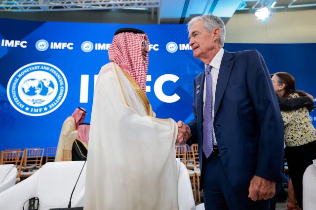 (L/R) Saudi Arabia's Finance Minister Mohammed Al-Jadaan shakes hands with US Federal Reserve Chair Jerome Powell during a meeting of the IMFC (International Monetary and Financial Committee) at the 2026 IMF and World Bank Group Spring Meetings in Washington, DC, on April 17, 2026. (Photo by Kent NISHIMURA / AFP)