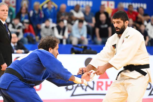 Georgia's Lasha Shavdatuashvili (white) and Azerbaijan's Hidayat Heydarov compete in the men's under 73 kg category gold medal bout at the Judo European Senior Championships 2026 in Tbilisi on April 17, 2026. (Photo by Vano SHLAMOV / AFP)