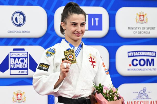 Gold medallist Georgia's Eteri Liparteliani celebrates on the podium for the women's under 57 kg category event at the Judo European Senior Championships 2026 in Tbilisi on April 17, 2026. (Photo by Vano SHLAMOV / AFP)
