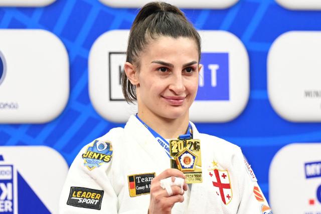 Gold medallist Georgia's Eteri Liparteliani celebrates on the podium for the women's under 57 kg category event at the Judo European Senior Championships 2026 in Tbilisi on April 17, 2026. (Photo by Vano SHLAMOV / AFP)