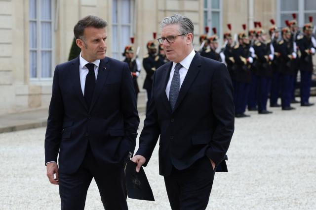France's President Emmanuel Macron (L) escorts British Prime Minister Keir Starmer in the courtyard as part of a meeting of allies to consider sending a multinational force to ensure security and free-flowing trade in the Strait of Hormuz, at the presidential Elysee Palace in Paris on April 17, 2026. Emmanuel Macron on April 17, 2026 urged the unconditional reopening of the Strait of Hormuz after Tehran declared that the key shipping route would be open as long as a ceasefire in the Middle East lasts. (Photo by Ludovic MARIN / AFP)