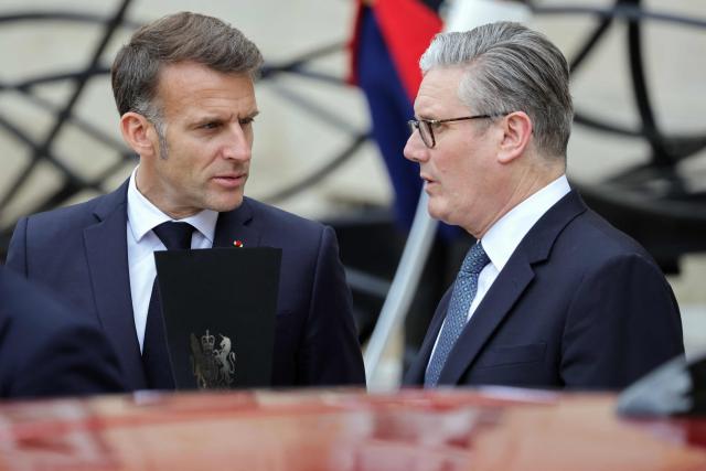 France's President Emmanuel Macron (L) talks to British Prime Minister Keir Starmer in the courtyard as part of a meeting of allies to consider sending a multinational force to ensure security and free-flowing trade in the Strait of Hormuz, at the presidential Elysee Palace in Paris on April 17, 2026. Emmanuel Macron on April 17, 2026 urged the unconditional reopening of the Strait of Hormuz after Tehran declared that the key shipping route would be open as long as a ceasefire in the Middle East lasts. (Photo by Ludovic MARIN / AFP)