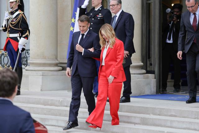 France's President Emmanuel Macron (L) followed by Britain's Prime Minister Keir Starmer, talks to Italian Prime Minister Giorgia Meloni in the courtyard at the end of a meeting of allies to consider sending a multinational force to ensure security and free-flowing trade in the Strait of Hormuz, at the presidential Elysee Palace in Paris on April 17, 2026. Emmanuel Macron on April 17, 2026 urged the unconditional reopening of the Strait of Hormuz after Tehran declared that the key shipping route would be open as long as a ceasefire in the Middle East lasts. (Photo by Ludovic MARIN / AFP)