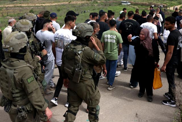 A Palestinian woman reacts towards Israeli security forces as they forcibly remove Palestinians trying to reach their land after Israeli settlers reportedly attacked local farmers working on their land, spraying them with pepper spray, near the Palestinian village of Halhoul, south of the Israel-occupied West Bank city of Hebron, on April 17, 2026. Violence in the Palestinian West Bank, which Israel has occupied since 1967, has soared since the Hamas attack on Israel triggered the Gaza war in October 2023. (Photo by HAZEM BADER / AFP)
