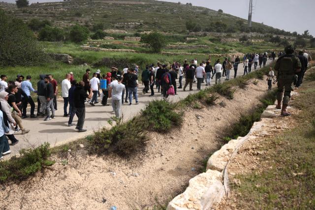 Israeli security forces (R) forcibly remove Palestinians trying to reach their land after Israeli settlers reportedly attacked local farmers working on their land, spraying them with pepper spray, near the Palestinian village of Halhoul, south of the Israel-occupied West Bank city of Hebron, on April 17, 2026. (Photo by HAZEM BADER / AFP)