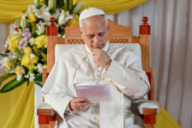 Pope Leo XIV reads a document as he meets with university students and professors at the Catholic University of Central Africa in Yaounde on the fifth day of an 11-day apostolic journey to Africa, on April 17, 2026. (Photo by Alberto PIZZOLI / AFP)