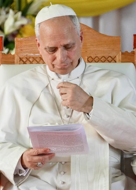 Pope Leo XIV reads a document as he meets with university students and professors at the Catholic University of Central Africa in Yaounde on the fifth day of an 11-day apostolic journey to Africa, on April 17, 2026. (Photo by Alberto PIZZOLI / AFP)