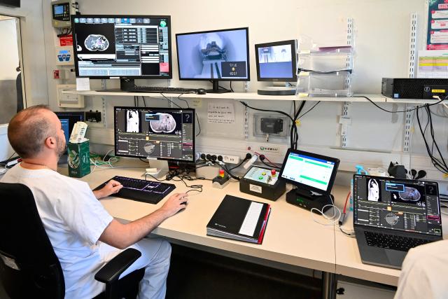 Researchers work at the radiotherapy control room of the Montpellier Cancer Institute, in Montpellier, southern France, on April 17, 2026. (Photo by Sylvain THOMAS / AFP)