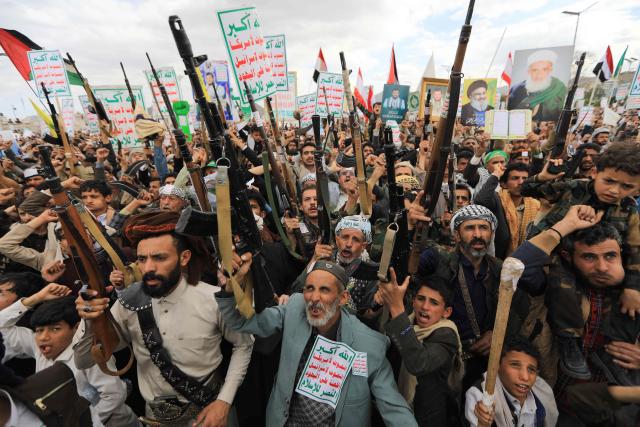Supporters of the Iran-backed Houthi movement brandish their weapons as they rally in solidarity with Iran and Lebanon in the Yemeni capital Sanaa on April 17, 2026. The Middle East war has created an "unprecedented shock" for the region's economies with no guarantee of a quick recovery, a senior International Monetary Fund official has told AFP. Five of the Gulf's eight oil- and gas-producing countries face a contraction this year, the IMF said in a regional report published on April 16. (Photo by Mohammed HUWAIS / AFP)