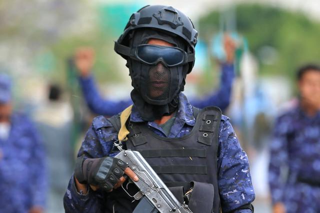 A security personnel officer stands guard during a rally by supporters of the Iran-backed Houthi movement in solidarity with Iran and Lebanon amid the Middle East war, in the capital Sanaa on April 17, 2026. The Middle East war has created an "unprecedented shock" for the region's economies with no guarantee of a quick recovery, a senior International Monetary Fund official has told AFP. Five of the Gulf's eight oil- and gas-producing countries face a contraction this year, the IMF said in a regional report published on April 16. (Photo by Mohammed HUWAIS / AFP)