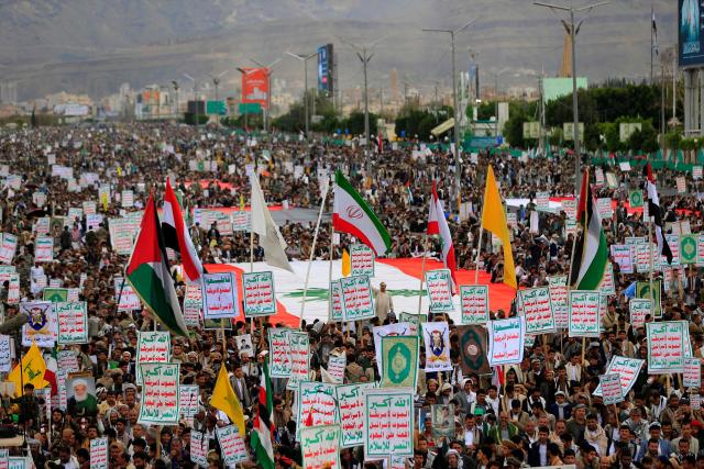 Hundreds of supporters of the Iran-backed Houthi movement brandish their weapons, banners and flags as they rally in solidarity with Iran and Lebanon in the Yemeni capital Sanaa on April 17, 2026. The Middle East war has created an "unprecedented shock" for the region's economies with no guarantee of a quick recovery, a senior International Monetary Fund official has told AFP. Five of the Gulf's eight oil- and gas-producing countries face a contraction this year, the IMF said in a regional report published on April 16. (Photo by Mohammed HUWAIS / AFP)