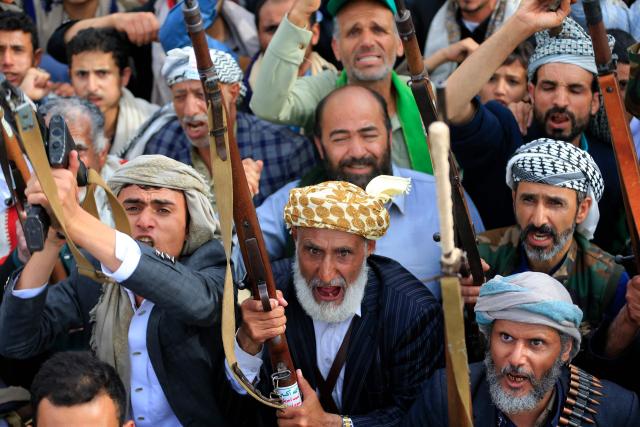 Supporters of the Iran-backed Houthi movement brandish their weapons as they rally in solidarity with Iran and Lebanon in the Yemeni capital Sanaa on April 17, 2026. The Middle East war has created an "unprecedented shock" for the region's economies with no guarantee of a quick recovery, a senior International Monetary Fund official has told AFP. Five of the Gulf's eight oil- and gas-producing countries face a contraction this year, the IMF said in a regional report published on April 16. (Photo by Mohammed HUWAIS / AFP)
