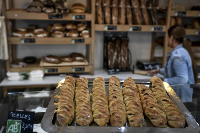 (FILES) This photograph taken on November 15, 2022 shows bread displayed at the organic Racynes bakery in Boulogne-Billancourt, outside Paris. Employees at independent bakeries and florists who wish to do so will be able to work on May 1, 2026, Labour Day, France's prime minister  announced on April 17, 2026, after rejecting a bill that would have allowed work to be extended on this public holiday. (Photo by STEPHANE DE SAKUTIN / AFP)