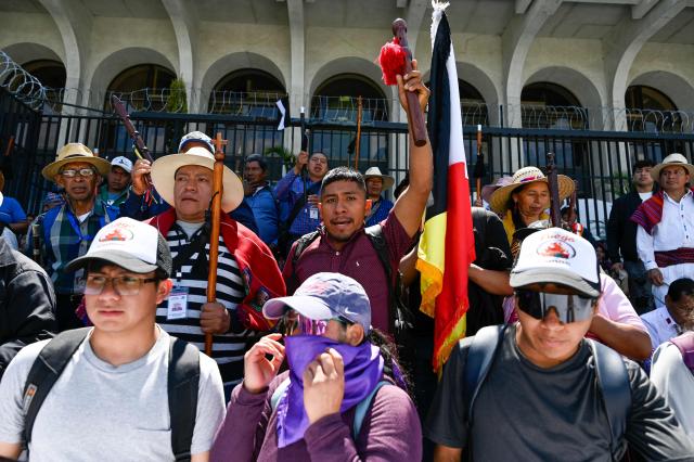 People protest against the nomination of Consuelo Porras for a third term as attorney general outside the Palace of Justice in Guatemala City on April 17, 2026. The official is seeking a third four-year term despite the United States, Canada, the United Kingdom and the European Union, along with around a dozen allied countries, revoking her visa for undermining democracy. (Photo by Johan ORDONEZ / AFP)