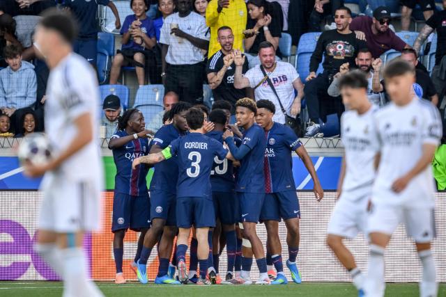 Paris Saint-Germain's team player celebrates their team's first goal scored by Paris Saint-Germain's French forward Elijah Ly during the the UEFA Youth League semi-final football match between Real Madrid and Paris Saint-Germain at Stade de la Tuiliere in Lausanne, on April 17, 2026. (Photo by Fabrice COFFRINI / AFP)
