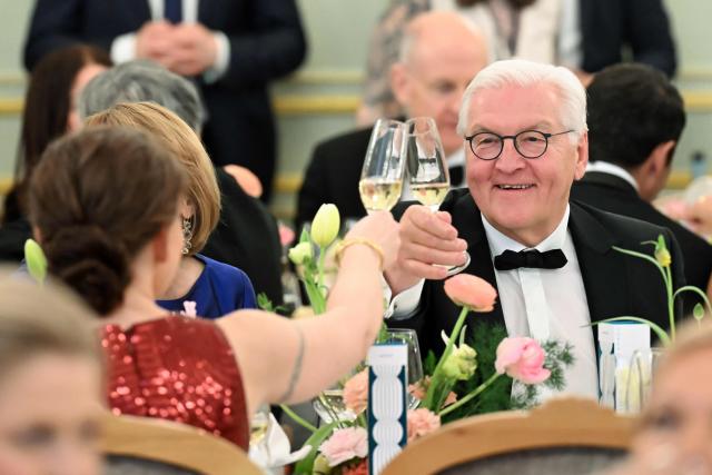 Germany's President Frank-Walter Steinmeier stösst beim Dinner des Bundespresseballs mit Regina Kramer, Ehefau des Vorsitzender der Bundespressekonferenz, at the dinner table during the Bundespresseball (German Federal Press Ball) in Berlin, Germany, on April 18, 2026. (Photo by Annette Riedl / dpa pool / AFP)
