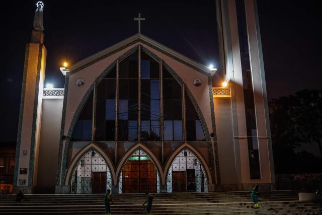 Workers sweep outside the Parish of Our Lady of Fatima ahead a visit of Pope Leo XIV to Angola as part of an 11-day apostolic journey to Africa, in Luanda, on April 17, 2026. (Photo by Phill Magakoe / AFP)