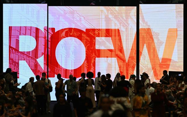The event logo is projected onto a screen during Rio Fashion Week at Pier Maua in Rio de Janeiro, Brazil, on April 17, 2026. (Photo by Mauro PIMENTEL / AFP)