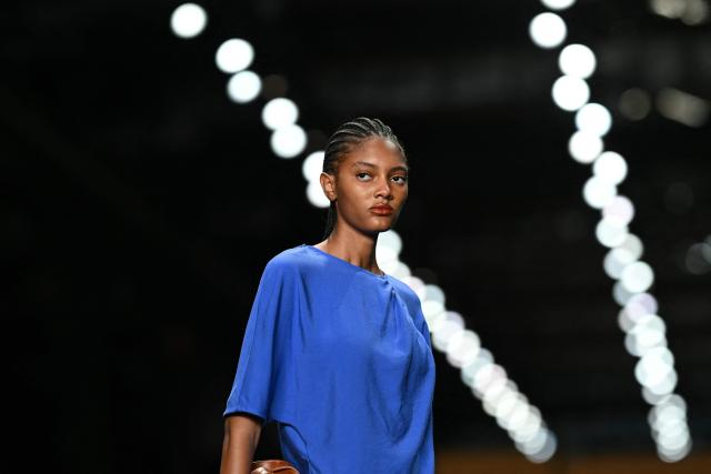 A model presents a creation by Angela Brito during Rio Fashion Week at Pier Maua in Rio de Janeiro, Brazil, on April 17, 2026. (Photo by Mauro PIMENTEL / AFP)