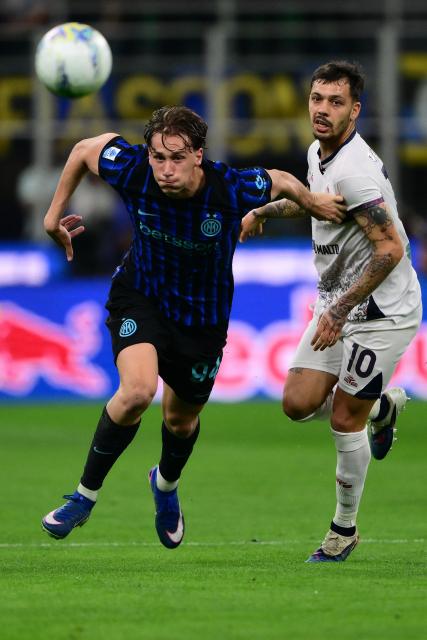 Inter Milan’s Italian forward #94 Francesco Pio Esposito fights for the ball with Cagliari’s Italian midfielder #10 Gianluca Gaetano during the Italian Serie A football match between Inter Milan and Cagliari at San Siro stadium in Milan, on April 17, 2026. (Photo by MARCO BERTORELLO / AFP)