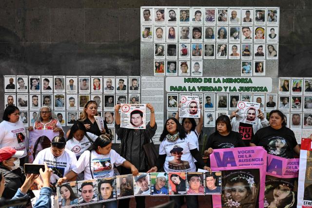 Members of the collective for the search of missing persons, “Una Luz en el Camino,” take part in a press conference at the so?called Wall of Memory for Truth and Justice, located at the headquarters of the Comprehensive Care Center for the Search for Persons in Mexico City, on April 17, 2026. Several groups searching for missing persons announced on April 17 the discovery of more than 1,000 bone fragments in a lakeside area of Mexico City, where Mexican authorities have been carrying out excavations for more than a week. (Photo by Yuri CORTEZ / AFP)