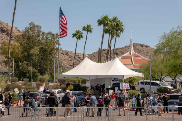 People protest the US president's visit to Arizona outside Dream City Church, where the Turning Point USA "Build the Red Wall" event is being held, in Phoenix, Arizona, on April 17, 2026. President Trump is in Arizona to speak at a Turning Point USA event, the conservative political organization founded by late activist Charlie Kirk. (Photo by Olivier Touron / AFP)