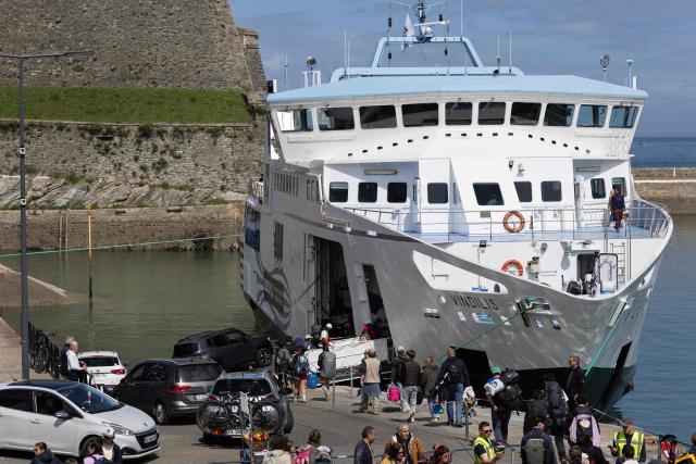 Cars and pedestrians embark on a ferry in Belle-Ile-en-Mer, western France, on April 17, 2026. (Photo by Fred TANNEAU / AFP)