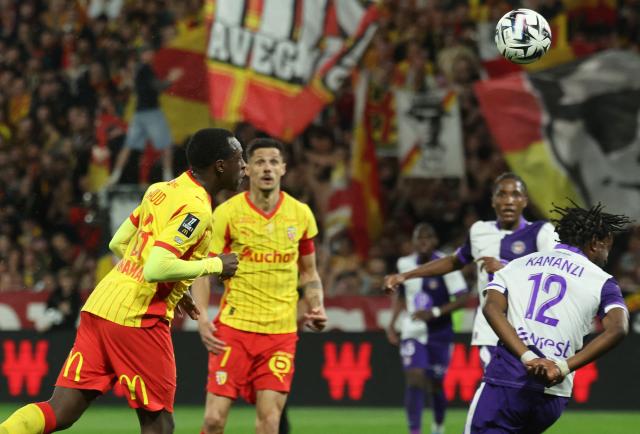 Lens' Saudi Arabian defender #23 Saud Abdulhamid goes for a header and scores his team first goal during the French L1 football match between RC Lens and Toulouse FC at the Stade Bollaert-Delelis in Lens, northern France, on April 17, 2026. (Photo by Francois LO PRESTI / AFP)