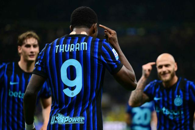 Inter Milan's French forward #9 Marcus Thuram celebrates scoring his team's first goal with Inter Milan's Italian defender #32 Federico Dimarco (R) during the Italian Serie A football match between Inter Milan and Cagliari at San Siro stadium in Milan, on April 17, 2026. (Photo by Marco BERTORELLO / AFP)