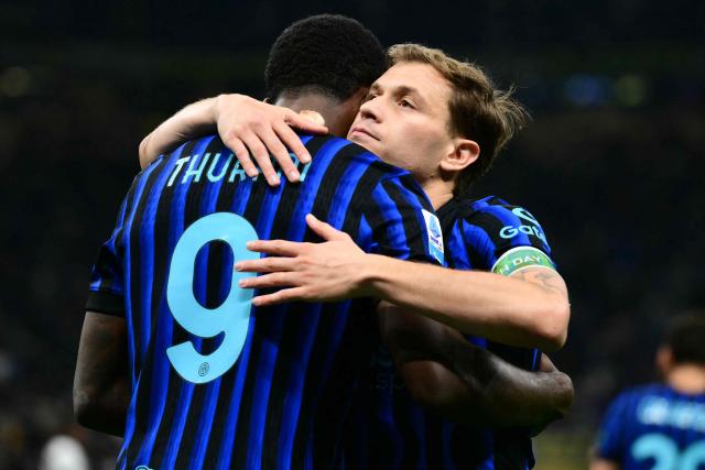 Inter Milan's French forward #9 Marcus Thuram celebrates his team's first goal with Inter Milan's Italian midfielder #23 Nicolo Barella during the Italian Serie A football match between Inter Milan and Cagliari at San Siro stadium in Milan, on April 17, 2026. (Photo by Marco BERTORELLO / AFP)