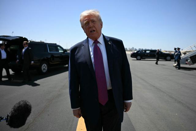 US President Donald Trump speaks to reporters upon arrival Phoenix Sky Harbor International Airport in Phoenix, Arizona, on April 17, 2026. Trump is in Phoenix to address a Turning Point USA event. (Photo by Jim WATSON / AFP)