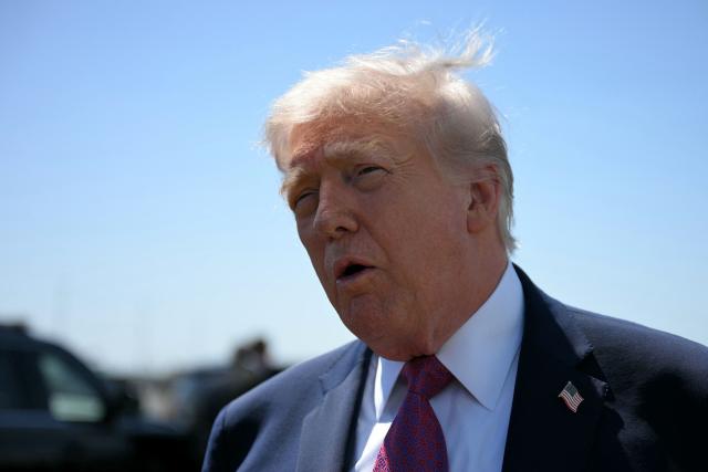US President Donald Trump speaks to reporters upon arrival at Phoenix Sky Harbor International Airport in Phoenix, Arizona, on April 17, 2026. Trump is in Phoenix to address a Turning Point USA event. (Photo by Jim WATSON / AFP)