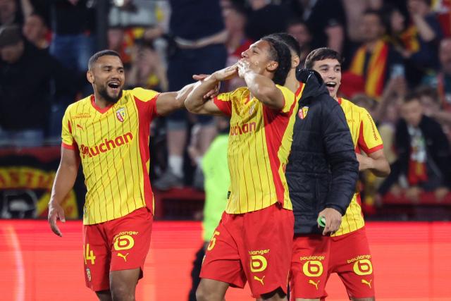 Lens' French defender Pierre Ismaelo Ganiou (C) celebrates with teammates  after scoring a goal during the French L1 football match between RC Lens and Toulouse FC at the Stade Bollaert-Delelis in Lens, northern France, on April 17, 2026. (Photo by Francois LO PRESTI / AFP)