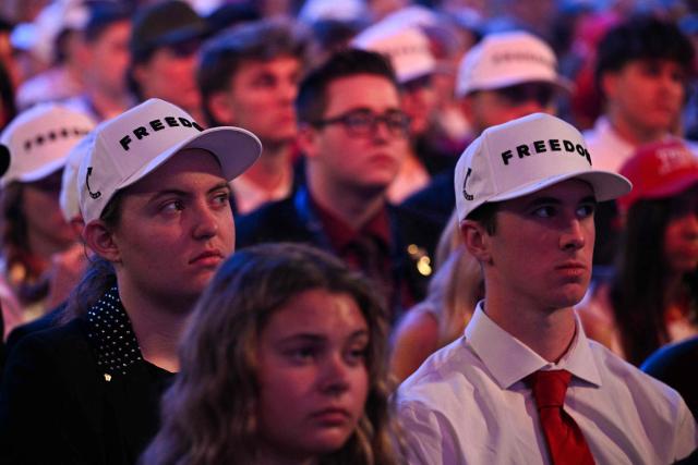 Attendees wear hats reading "freedom" during a Turning Point USA event at Dream City Church in Phoenix, Arizona, on April 17, 2026. (Photo by Jim WATSON / AFP)