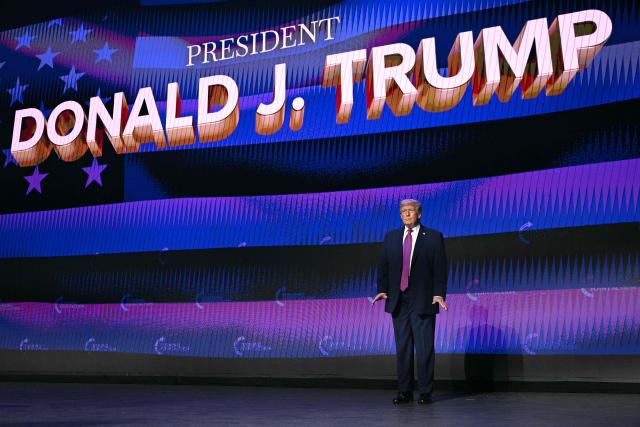US President Donald Trump arrives on stage to address a Turning Point USA event at Dream City Church in Phoenix, Arizona, on April 17, 2026. (Photo by Jim WATSON / AFP)