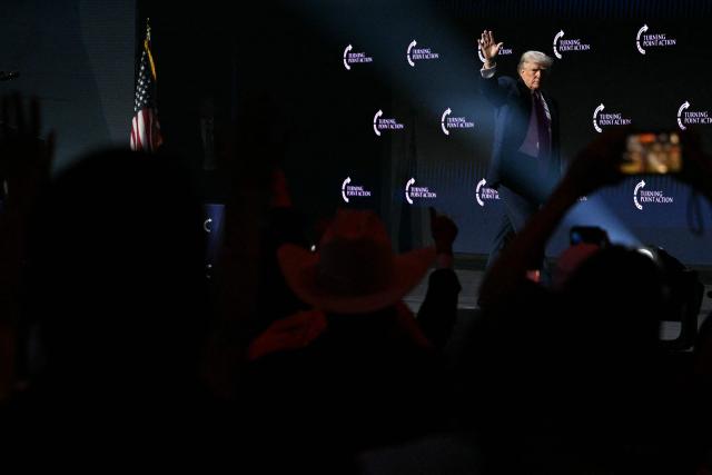 US President Donald Trump waves as he leaves the stage after addressing a Turning Point USA event entitled "Build the Red Wall" at Dream City Church in Phoenix, Arizona, on April 17, 2026. (Photo by Jim WATSON / AFP)