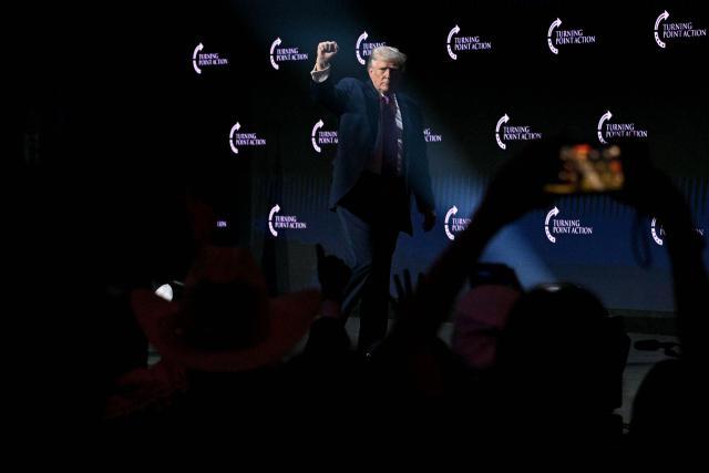 US President Donald Trump raises his fist as he leaves the stage after addressing a Turning Point USA event entitled "Build the Red Wall" at Dream City Church in Phoenix, Arizona, on April 17, 2026. (Photo by Jim WATSON / AFP)
