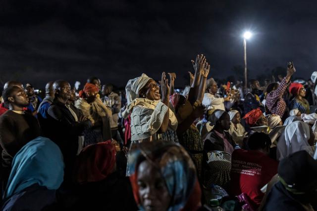 People sing during a night vigil prayer on the fifth day of Pope Leo XIV’s 11-day apostolic journey to Africa in Yaounde, Cameroon, on April 17, 2026. (Photo by PATRICK MEINHARDT / AFP)