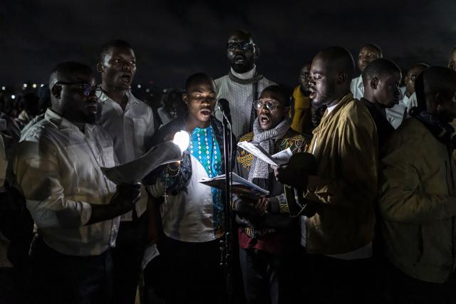 Members of a choir sing during a night vigil prayer on the fifth day of Pope Leo XIV’s 11-day apostolic journey to Africa in Yaounde, Cameroon, on April 17, 2026. (Photo by PATRICK MEINHARDT / AFP)