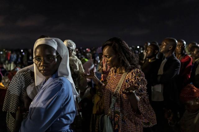 A woman prays during a night vigil prayer on the fifth day of Pope Leo XIV’s 11-day apostolic journey to Africa in Yaounde, Cameroon, on April 17, 2026. (Photo by PATRICK MEINHARDT / AFP)