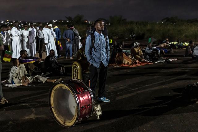 A man stands next to instruments as he attends a night vigil prayer on the fifth day of Pope Leo XIV’s 11-day apostolic journey to Africa in Yaounde, Cameroon, on April 17, 2026. (Photo by PATRICK MEINHARDT / AFP)