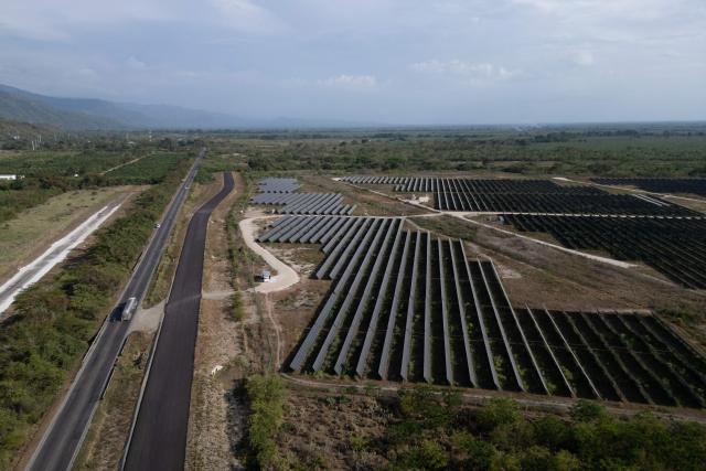 Aerial view of the solar park in Zona Bananera, Prado Sevilla, Magdalena department, Colombia on April 17, 2026. Co-organised by the governments of Colombia and the Netherlands, the first conference on the transition away from fossil fuels will be held in Santa Marta on April 28 and 29, 2026, with representatives of more than 50 countries attending. (Photo by Luis Acosta / AFP)