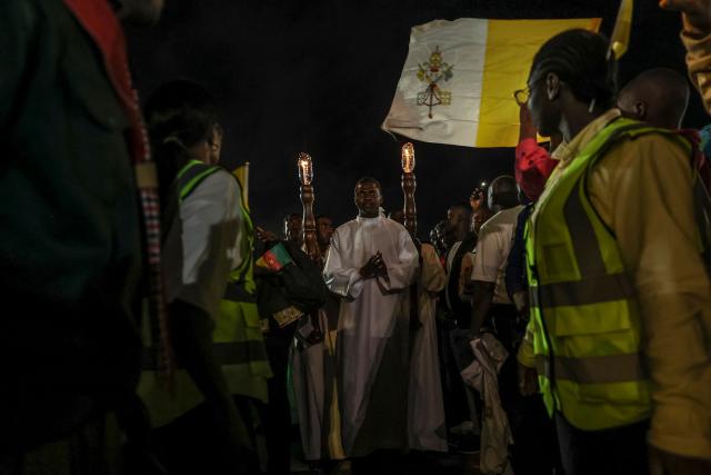 Altar servers lead a procession during a night vigil prayer on the fifth day of Pope Leo XIV’s 11-day apostolic journey to Africa in Yaounde, Cameroon, on April 17, 2026. (Photo by Daniel BELOUMOU OLOMO / AFP)