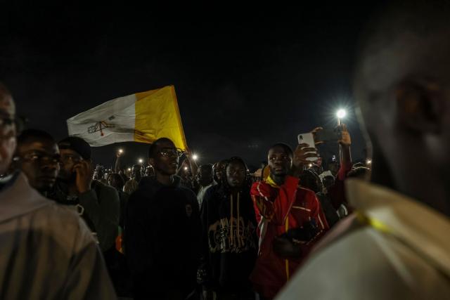 People attend a night vigil prayer on the fifth day of Pope Leo XIV’s 11-day apostolic journey to Africa in Yaounde, Cameroon, on April 17, 2026. (Photo by Daniel BELOUMOU OLOMO / AFP)