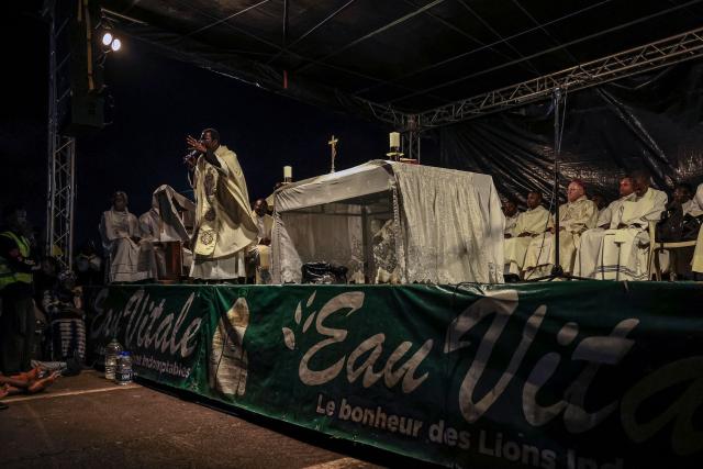 A priest speaks during a night vigil prayer on the fifth day of Pope Leo XIV’s 11-day apostolic journey to Africa in Yaounde, Cameroon, on April 17, 2026. (Photo by Daniel BELOUMOU OLOMO / AFP)