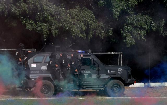 Jalisco state police officers attend a drill during the closing ceremony of the Urban Tactical Operations Course in Tlaquepaque, Jalisco, Mexico on April 17, 2026. The Urban Tactical Operations Course in conjunction with Colombian Police was part of the 2026 FIFA World Cup security preparations. (Photo by ULISES RUIZ / AFP)