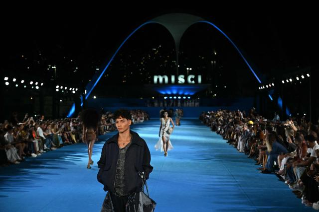 A model presents a creation by Misci during Rio Fashion Week at Marques de Sapucai sambadrome in Rio de Janeiro, Brazil on April 17, 2026. (Photo by Mauro PIMENTEL / AFP)