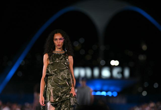 A model presents a creation by Misci during Rio Fashion Week at Marques de Sapucai sambadrome in Rio de Janeiro, Brazil on April 17, 2026. (Photo by Mauro PIMENTEL / AFP)